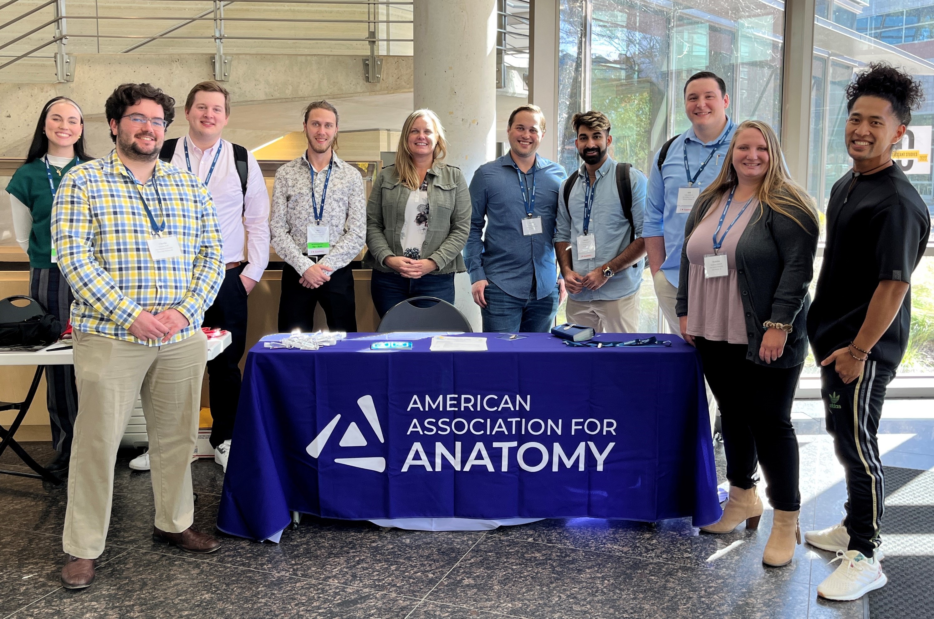 diverse group of people surrounding the AAA booth