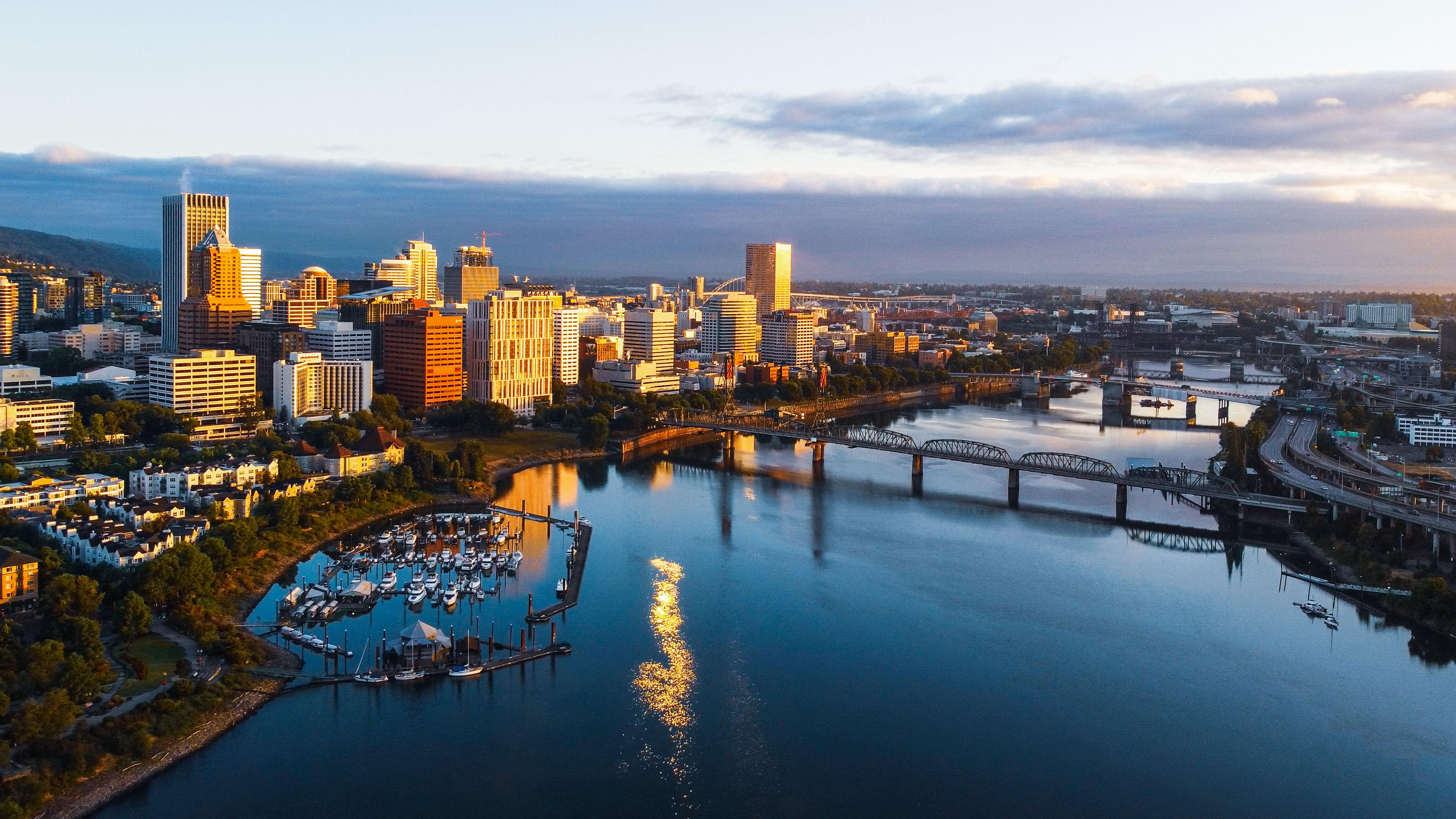 Downtown Portland Oregon aerial city scape, boats on the water, sunset